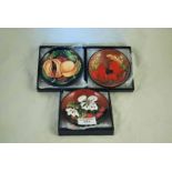 Three boxed Moorcroft Pottery pin dishes in the Poppy, Pomegranate and Cherry and Blossom
