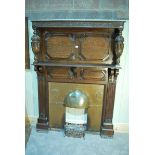 An early 20th century carved oak Fire Surround with foliate frieze, cup and cover balusters,