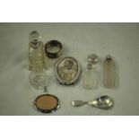 A small collection of hallmarked silver mounted Scent Bottles, Picture Brooch, Desk Frame, Napkin