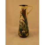 A Moorcroft Pottery tall jug in the Lamia design with water lilies and bulrushes by Rachel Bishop,