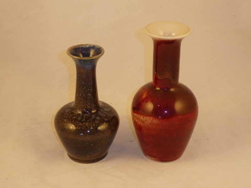 A Cobridge sprinkler vase with everted rim, in flambe glaze 18 cm H; together with a smaller example