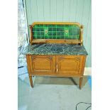 An early 20th century Edwardian oak Wash Stand, tiled and shelved back with black marble rectangular