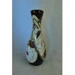 A Moorcroft Pottery elongated baluster vase in an unusual Hibiscus pattern by Sian Leeper, 20.5 cm H