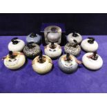 A collection of 12 Beneagles Scotch Whisky Decanters as miniature Curling Stones, ten with intact