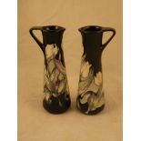 A pair of Moorcroft Pottery jugs in the Snow Tulip designed by Nicola Slaney, signed and with full