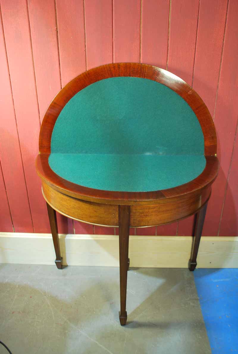 A 19th century style mahogany fold over top demi lune Card Table, typical form with green baise