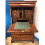 A George I walnut bureau a abattant, with cushion drawer and quarter matched fall opening to