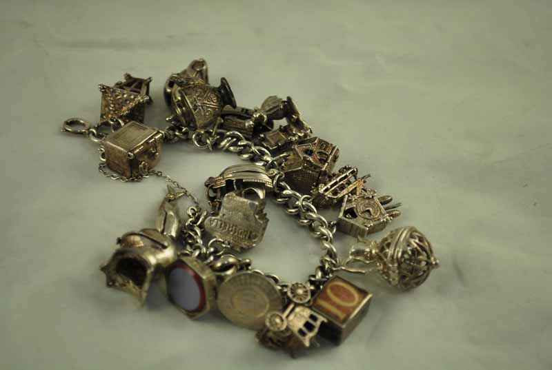A silver charm Bracelet with 18 silver and white metal charms including a sardonyx seal, 2.8ozt - Image 2 of 2