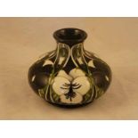 A Moorcroft Pottery squat baluster vase shape 32/5 in the Harlequinade pattern by Emma Bossons, 10.5