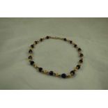 A 9ct gold and Lapis Lazuli bead Choker, marked to the clasp 19g gross