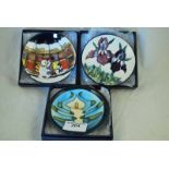 Three boxed Moorcroft Pottery pin dishes in the Iris, Seasons Greetings and Lily of the Valley