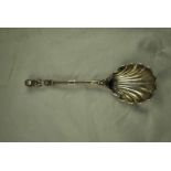 An Edward VII hallmarked silver shell shaped Serving Spoon with bust terminus and figural bowl