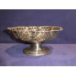 A 1930s pierced silver footed bowl, shaped oval form with cast scroll rim, pierced U shape panels
