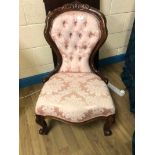 A Victorian mahogany show frame Nursing Chair, carved cresting rail and front cabriole legs,