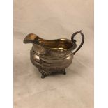 A regency period silver hallmarked milk jug, London 1822 by William Schofield, of helmet shape and