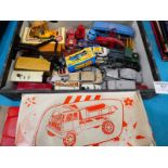 A collection of play worn die cast vehicles and a boxed plastic dump truck