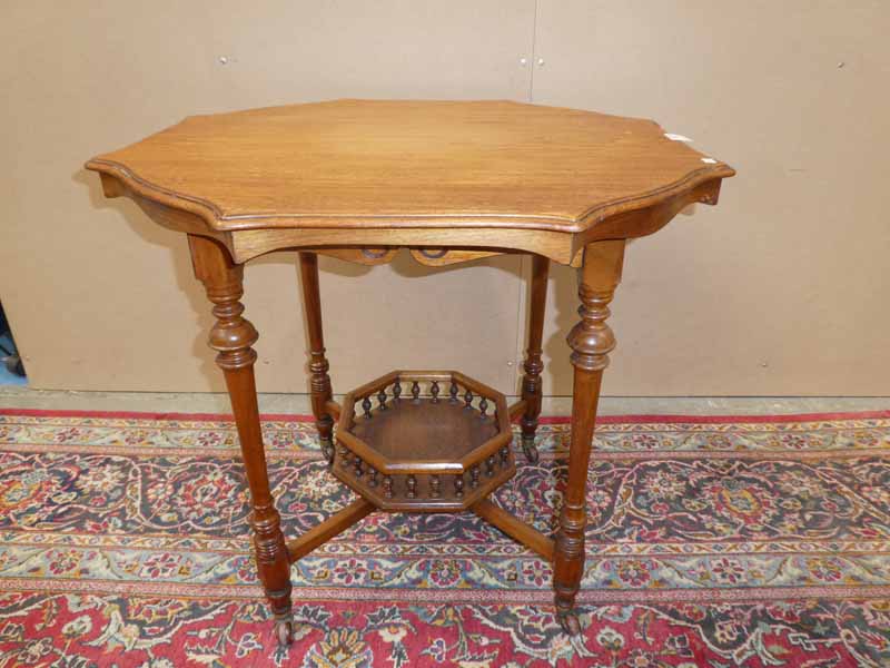 A late victorian mahagony occasional table with octagonal moulded edge, galleried under shelf on