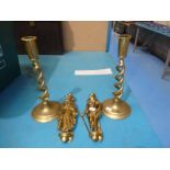 A pair of brass Dickens character door knockers and a pair of brass candlesticks