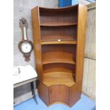 A 1980's G Plan teak corner display unit with four open shelves above a cabinet