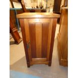 An Edwardian oak bedside pot cabinet