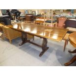 An oak refectory style dining table with a spare larger oak top