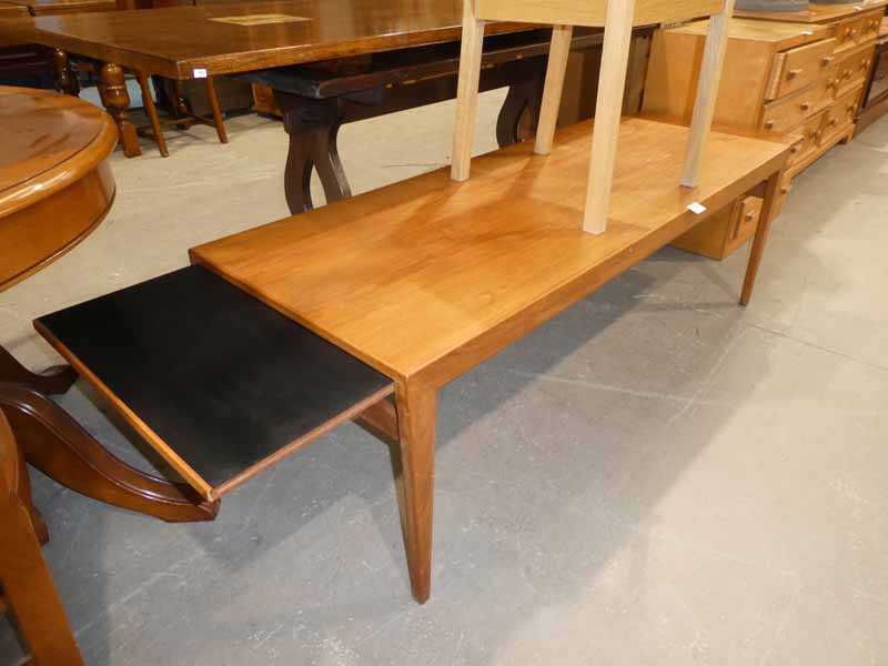 A 1960's teak rectangular extending magazine table with draw leaves at each end and a light ash