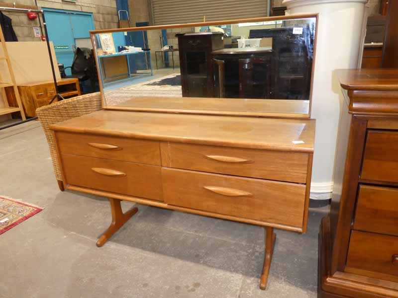 A 1970's teak dressing table with four drawers and framed rectangular mirror, vertical crack to