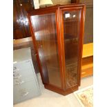 A 1990's mahogany corner display cabinet, freestanding with glazed door