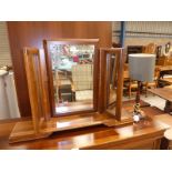 A freestanding toilet mirror and mahogany table lamp