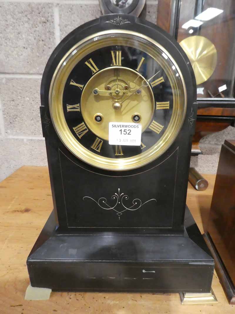 A black slate dome top French marble clock with brass and black face
