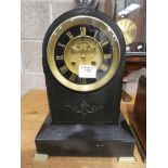 A black slate dome top French marble clock with brass and black face
