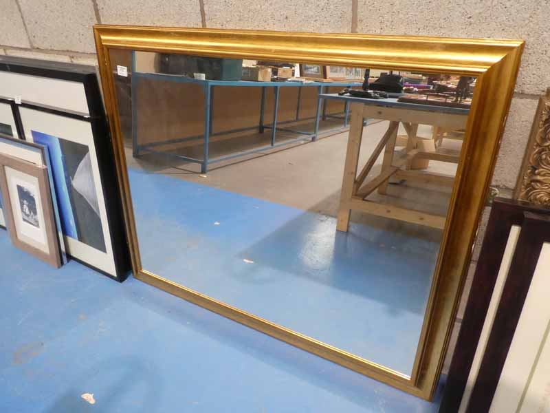 A large gilt framed wall mirror