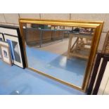 A large gilt framed wall mirror