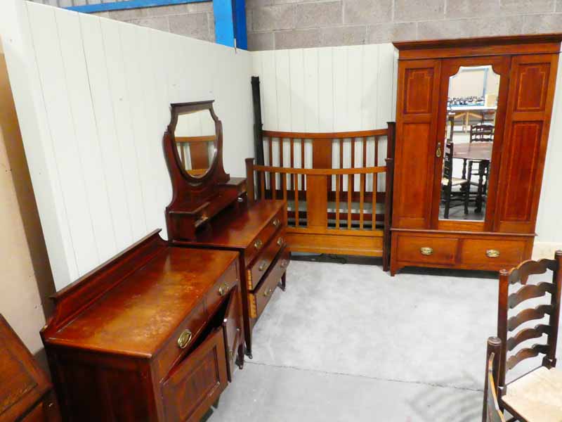 A late Victorian red walnut and inlaid four piece bedroom suite including bedstead