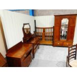 A late Victorian red walnut and inlaid four piece bedroom suite including bedstead