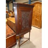 A 19th Century oak flat front corner cabinet on bobbin leg corner table support