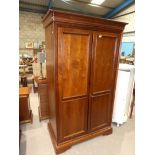 A modern Georgian style two door mahogany effect wardrobe with hanging space and shelf over