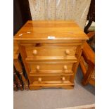 A pine three drawer bedside chest