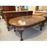 An Edwardian mahogany D-ended wind out Dining table with gadrooned edge, one spare leaf on