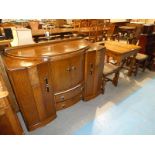 A 1920's oak fold over top extending dining table with four matching dining chairs and an Art Deco
