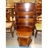 A reproduction mahogany effect waterfall book case and a small two tier hexagonal occasional table