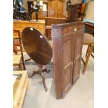 A Georgian mahogany circular tilt top table on triform support and a Georgian mahogany flat