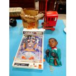 A Tomy atomic arcade pinball, triang tinplate crane and Cassius clay hand puppet