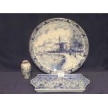 A 20th Century Dutch delft charger, small vase and rectangular tray