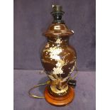 A decorative vase shape lamp base decorated with prunus blossom