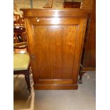 A freestanding mahogany cabinet with single door enclosing a shelved interior