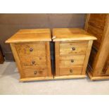 A pair of fruitwood bedside chests of three drawers to match previous lots