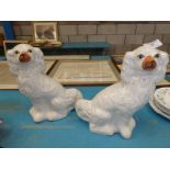A pair of staffordshire pottery fireside dogs