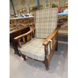 A William Morris inspired oak framed reclining chair with cushion seat and back