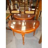 A small pair of Regency style Yew wood and crossbanded D shape occasional tables on three turned/